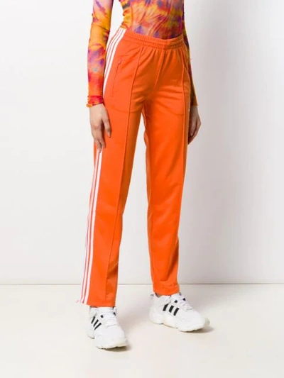 Shop Adidas Originals Logo Printed Track Pants In Orange