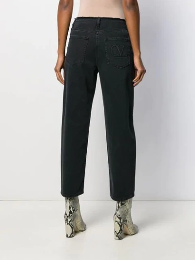 Shop Valentino Embroidered Quote Raw Hem Jeans In Black