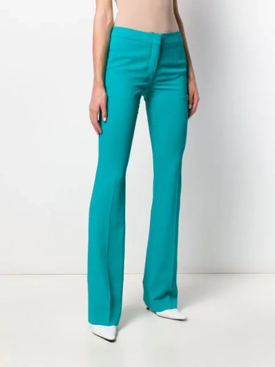 Shop Moschino Flared Mid-rise Trousers In Blue
