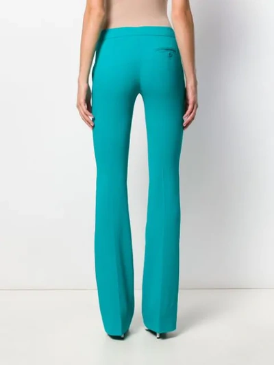 Shop Moschino Flared Mid-rise Trousers In Blue