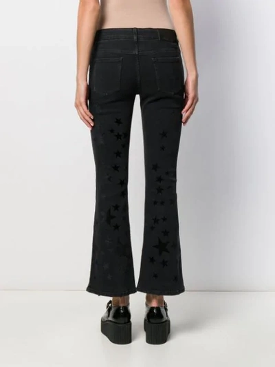 Shop Stella Mccartney Star Print Kick-flare Jeans In Black