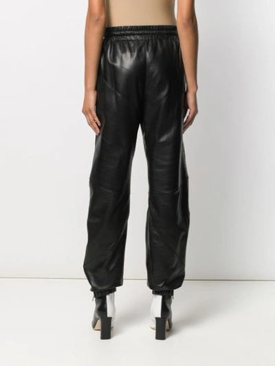 Shop Givenchy Zip Pocket Leather Trousers In Black