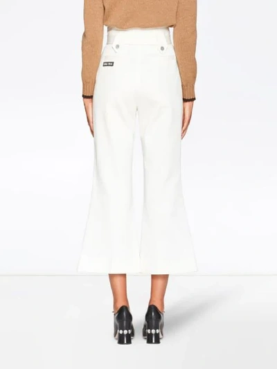 Shop Miu Miu Flared Belted Jeans In White