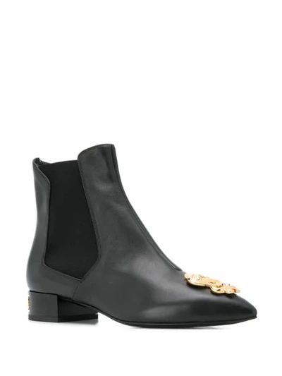 Shop Moschino Dollar Sign Plaque Ankle Boots In Black