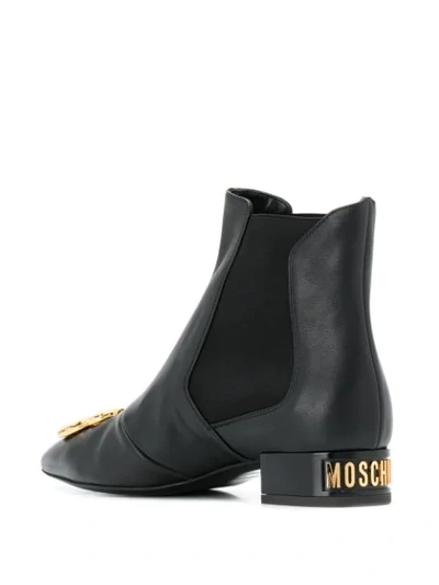 Shop Moschino Dollar Sign Plaque Ankle Boots In Black