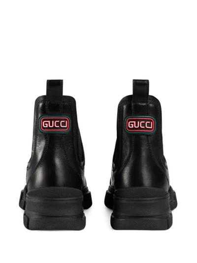 Shop Gucci Logo Patch Ankle Boots In Black