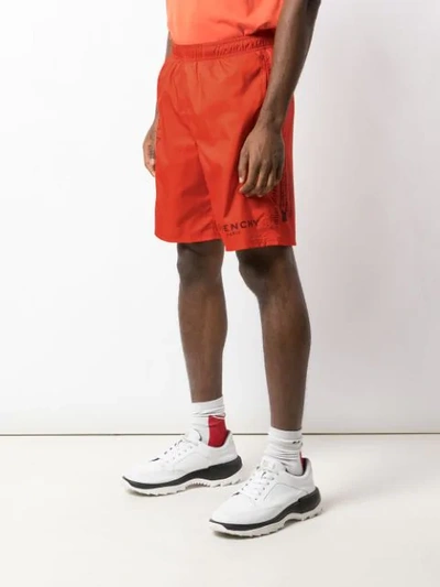 Shop Givenchy Logo Printed Track Shorts - Orange