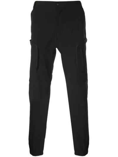 Shop White Mountaineering Tapered-leg Cargo Trousers In Black