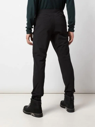 Shop White Mountaineering Tapered-leg Cargo Trousers In Black
