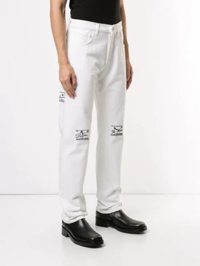 Shop Raf Simons Front Printed Trousers In White