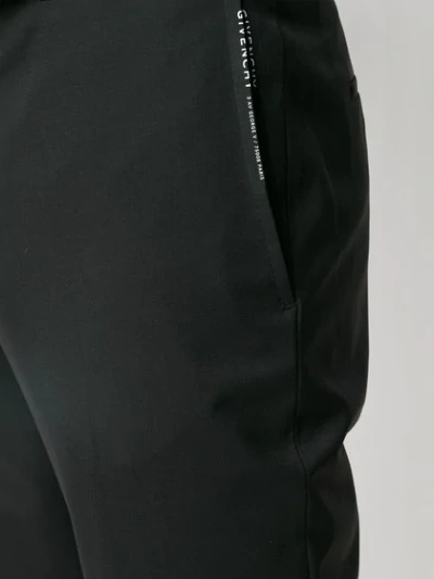 Shop Givenchy Ribbon Trimmed Logo Trousers In Black
