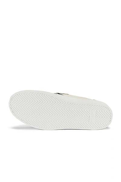 Shop Saint Laurent Venice Slip On In White & Black & Milk