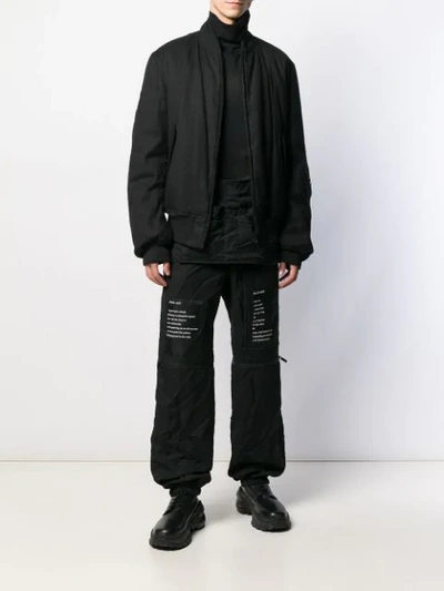 Shop Takahiromiyashita The Soloist Graphic-print Loose-fit Trousers In Black