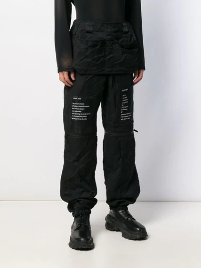 Shop Takahiromiyashita The Soloist Graphic-print Loose-fit Trousers In Black