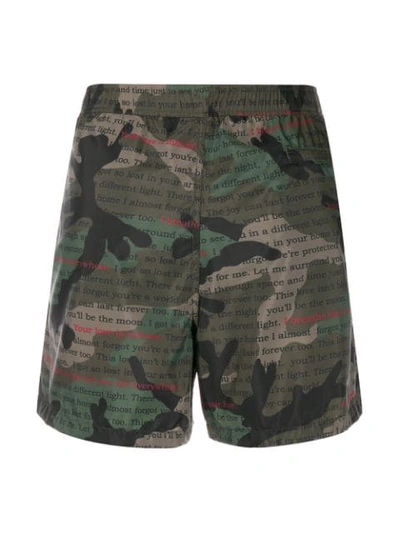 Shop Valentino Camouflage Text Print Swim Shorts In Green