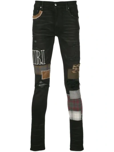 Shop Amiri Skinny Patchwork Jeans In Black