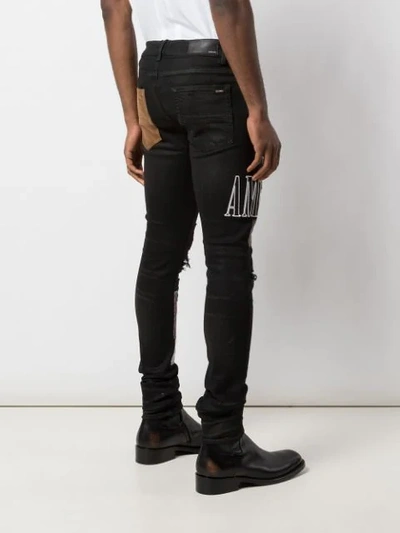 Shop Amiri Skinny Patchwork Jeans In Black