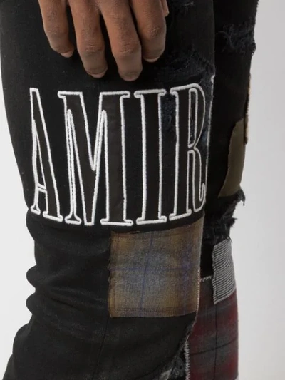 Shop Amiri Skinny Patchwork Jeans In Black