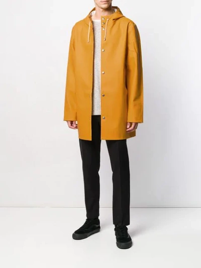 Shop Stutterheim Stockholm Hooded Raincoat In Yellow