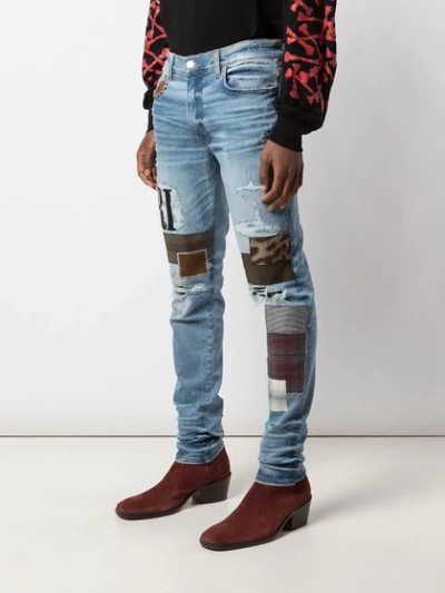 Shop Amiri Skinny Patchwork Jeans In Blue