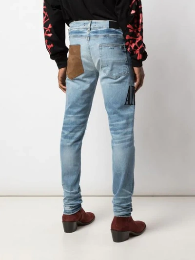 Shop Amiri Skinny Patchwork Jeans In Blue