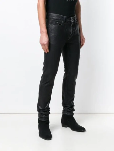 Shop Saint Laurent Wet Look Jeans In Black