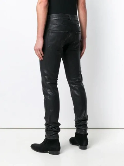 Shop Saint Laurent Wet Look Jeans In Black