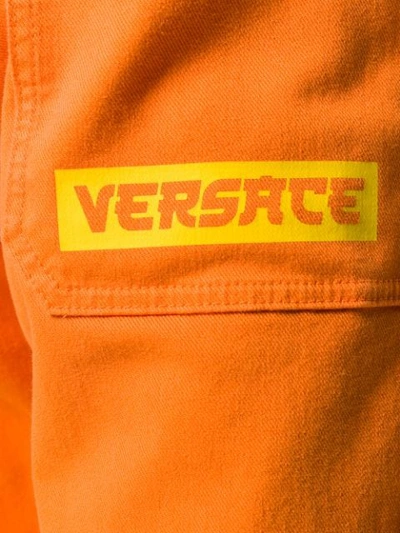 Shop Versace Wide-leg Long Jeans In Orange