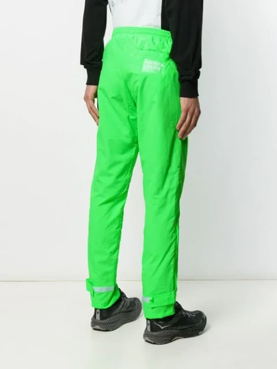 Shop Andrea Crews Piped Seam Track Pants In Green