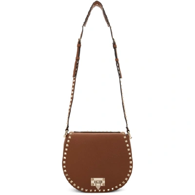 Shop Valentino Brown  Garavani Small Rockstud Saddle Bag In Hg5 Seleria