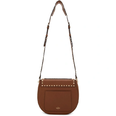 Shop Valentino Brown  Garavani Small Rockstud Saddle Bag In Hg5 Seleria