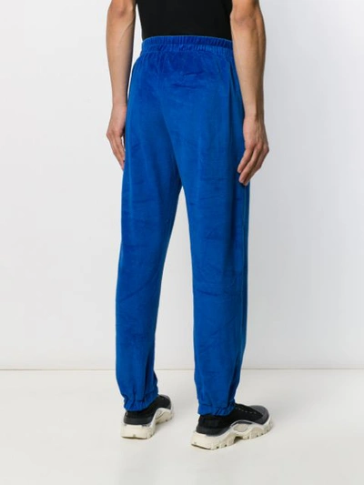 Shop Applecore Logo Embroidered Track Pants In Blue