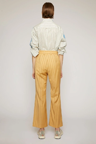 Flared pinstripe trousers Pale orange