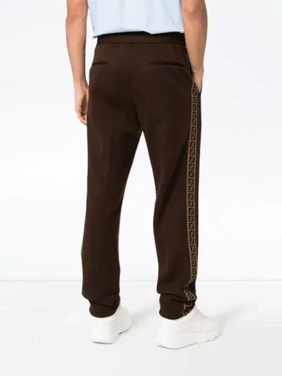 Shop Fendi Ff Ticker Tape Logo Trousers In Brown