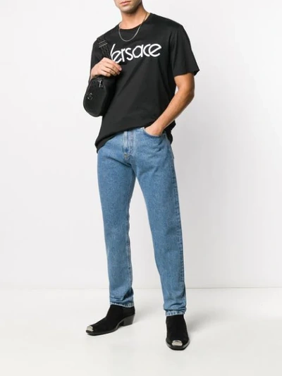 Shop Versace Embroidered Logo Straight Jeans In Blue