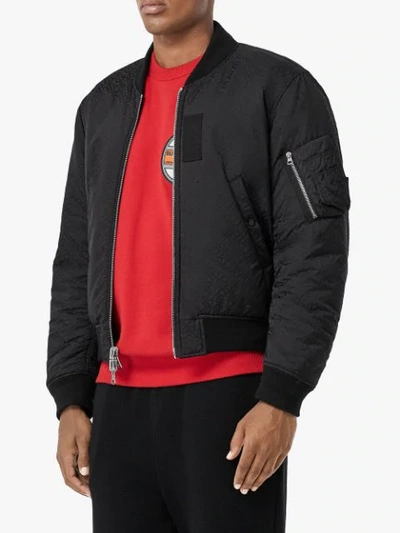 Shop Burberry Reversible Monogram Econyl® Jacquard Bomber Jacket In Black