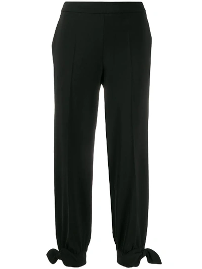 Shop Moschino Tied Ankle Trousers In Black