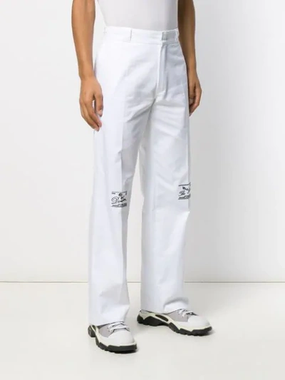 Shop Raf Simons Embroidered Straight-leg Trousers In 00010 White