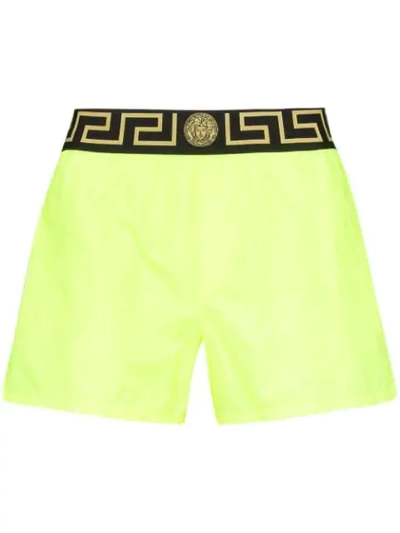 Shop Versace Greca Border Swim Shorts In Yellow