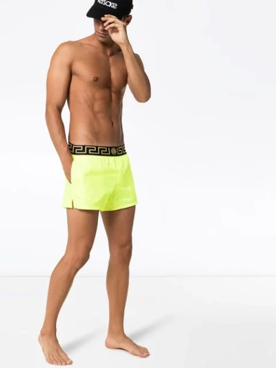 Shop Versace Greca Border Swim Shorts In Yellow