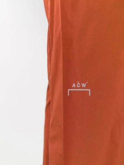 Shop A-cold-wall* Overlock Nylon Track Pants In Orange