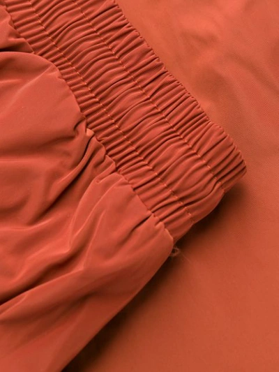Shop A-cold-wall* Overlock Nylon Track Pants In Orange