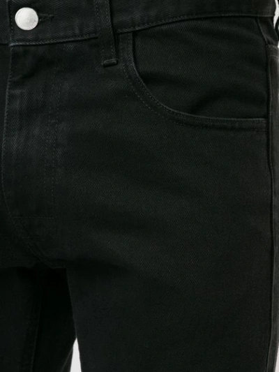 Shop Raf Simons Slim-fit Logo Patch Jeans In Black