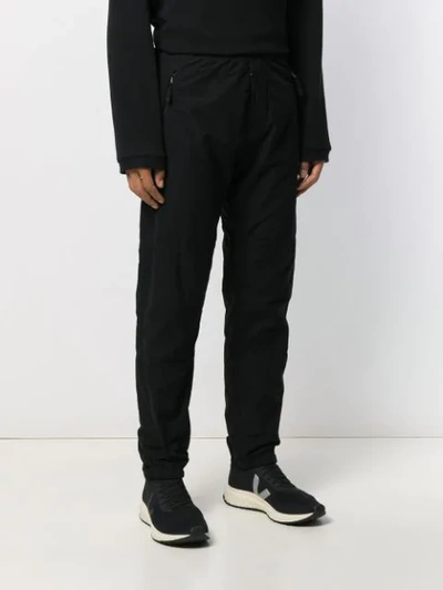 Shop Stone Island Logo Patch Trousers In Black