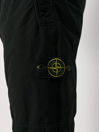 Shop Stone Island Logo Patch Trousers In Black