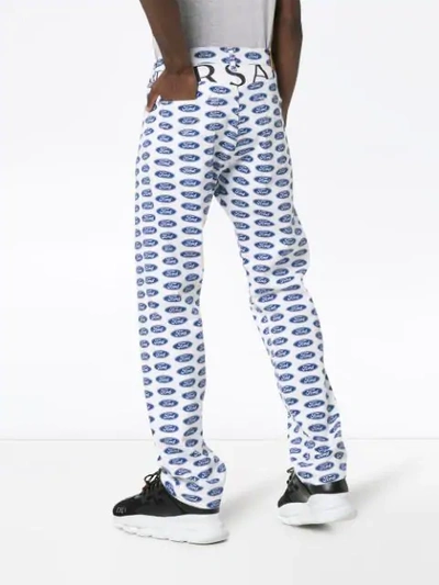 Shop Versace X Ford Logo Printed Jeans In Blue