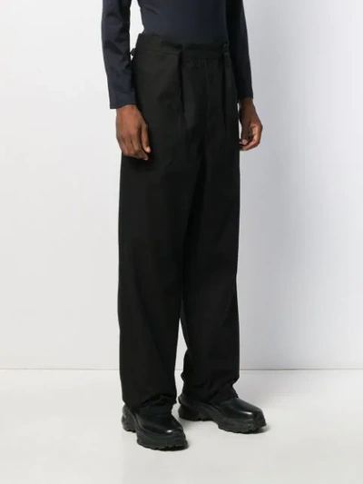 Shop Raf Simons Pleated Flared Trousers In Black