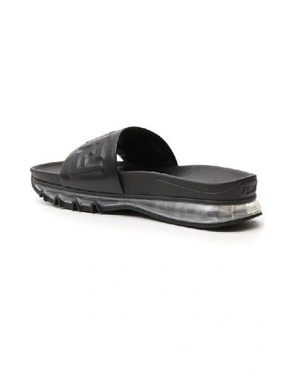 Shop Fendi Ff Monogram Embossed Slides In Black