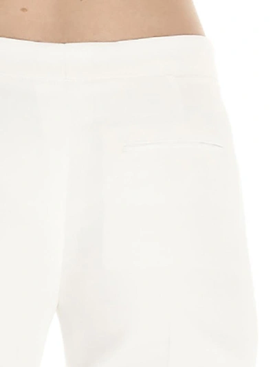 Shop Alexander Mcqueen Lace Hem Pants In White