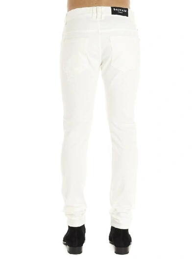 Shop Balmain Distressed Jeans In White